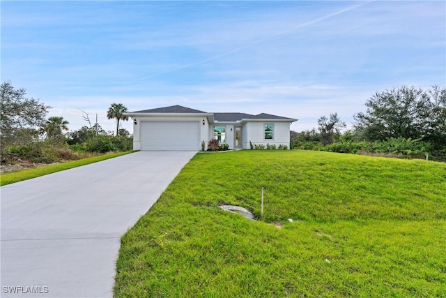 view of front of home with a garage and a front lawn