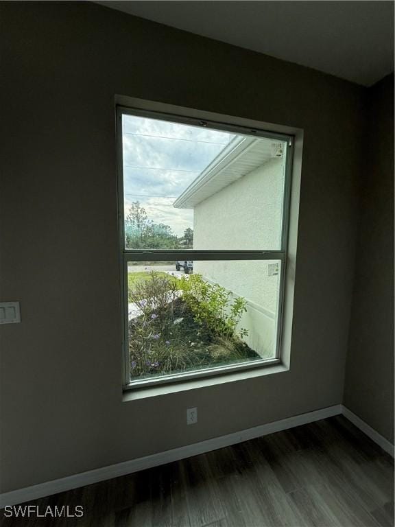 unfurnished room with wood-type flooring