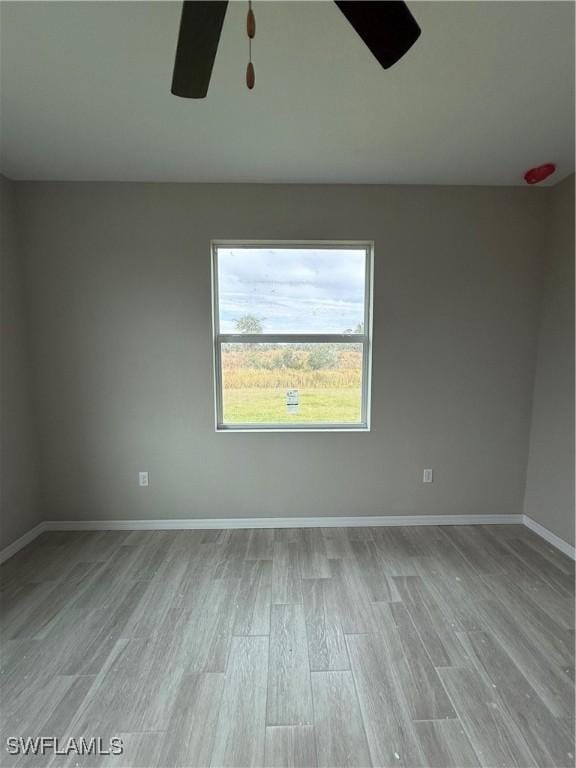 spare room featuring ceiling fan and light hardwood / wood-style floors