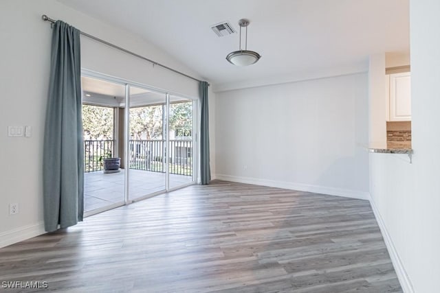 unfurnished room with hardwood / wood-style floors