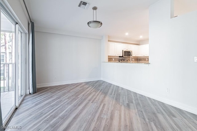 unfurnished living room featuring light wood-type flooring