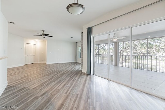 unfurnished living room with hardwood / wood-style flooring and ceiling fan