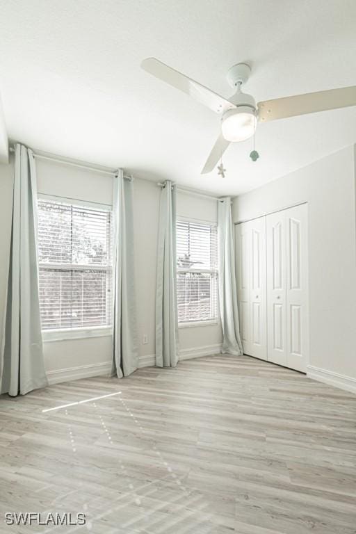 unfurnished bedroom featuring a closet and ceiling fan