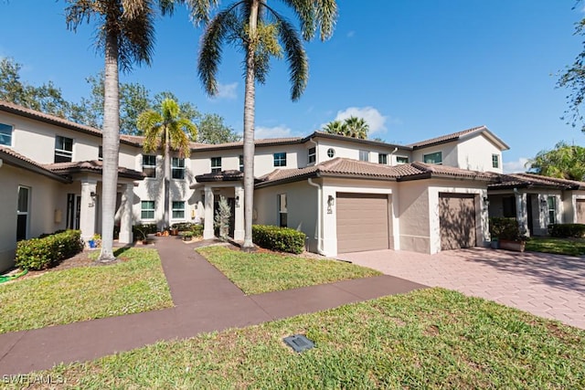 mediterranean / spanish-style home with a front yard and a garage