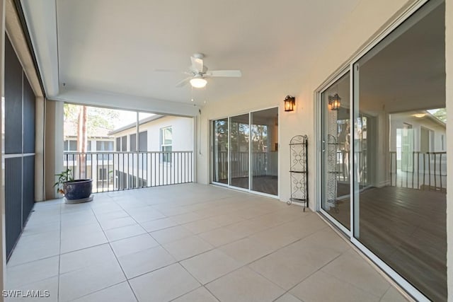 unfurnished sunroom with ceiling fan