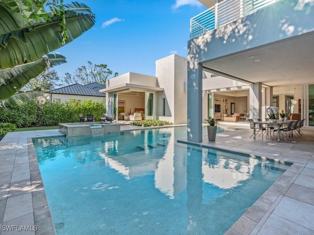 view of pool featuring a patio area and a pool with connected hot tub