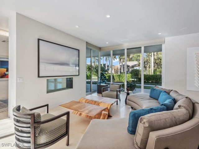 living area with expansive windows, plenty of natural light, and recessed lighting