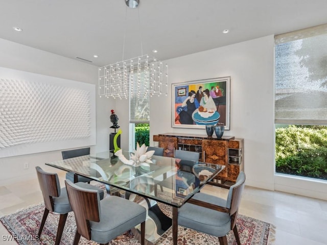 dining area with baseboards, recessed lighting, and a notable chandelier