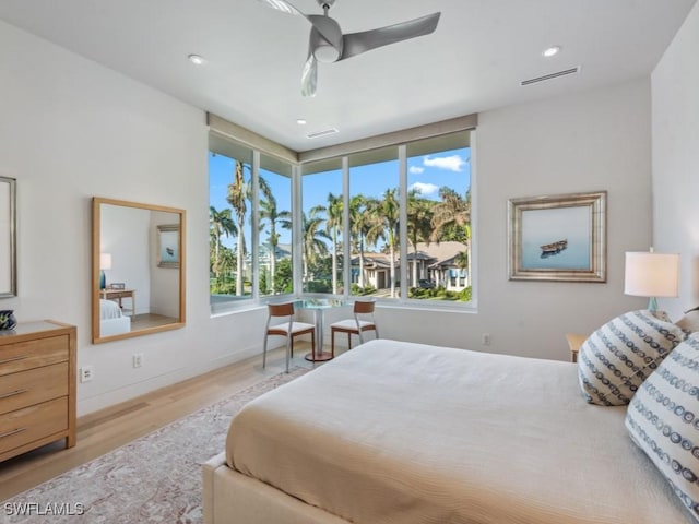 bedroom with a ceiling fan, visible vents, wood finished floors, and recessed lighting