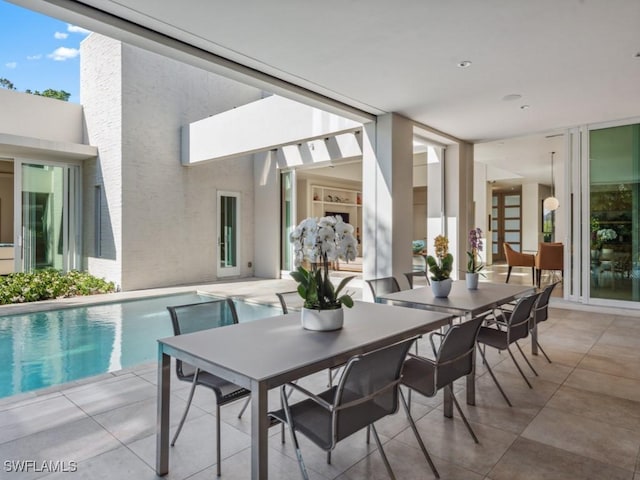 interior space featuring outdoor dining area and an outdoor pool