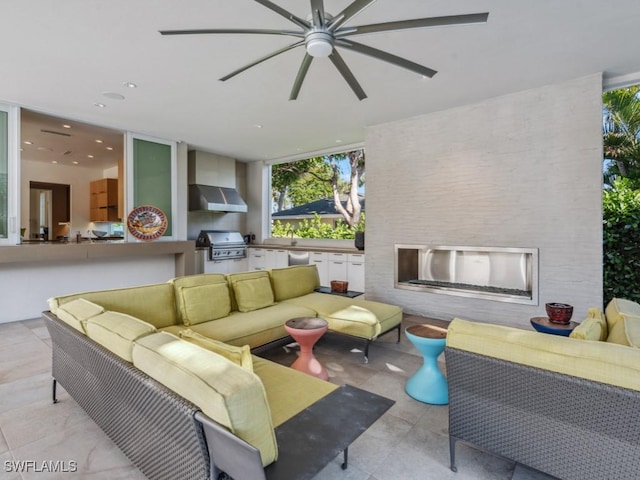 view of patio with exterior kitchen, ceiling fan, area for grilling, and an outdoor hangout area