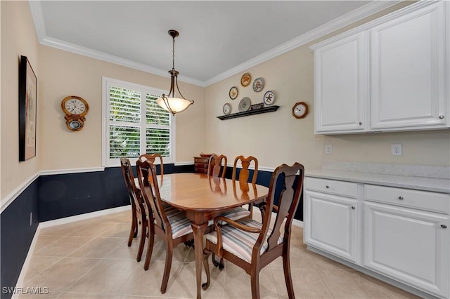 tiled dining room featuring ornamental molding