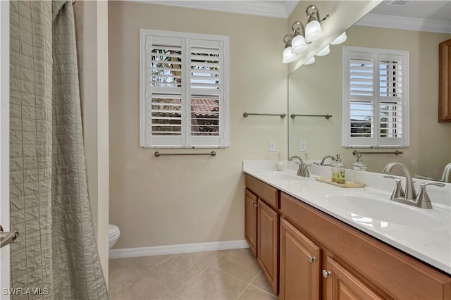 bathroom with a healthy amount of sunlight, vanity, tile patterned floors, and ornamental molding