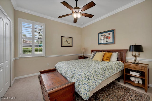 carpeted bedroom featuring ceiling fan and crown molding