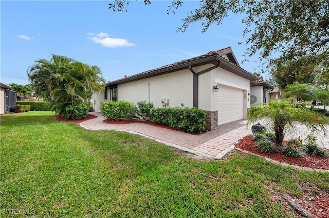 view of home's exterior featuring a garage and a lawn