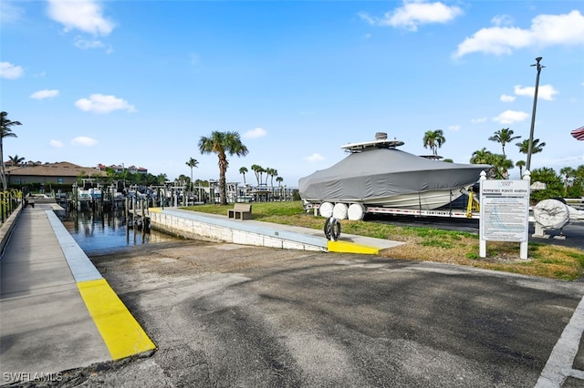 exterior space with a water view and a boat dock