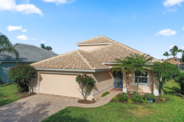 view of front of home featuring a garage and a front lawn