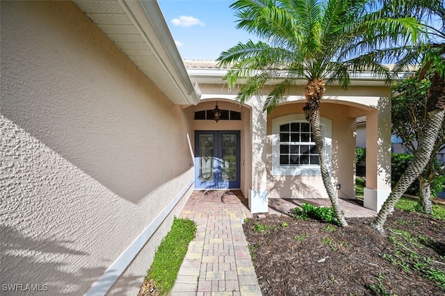 view of exterior entry featuring french doors