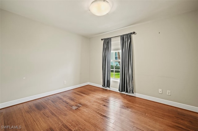 unfurnished room featuring hardwood / wood-style flooring