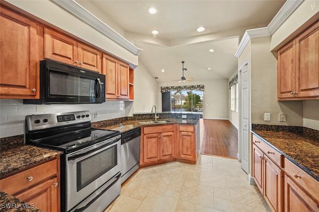 kitchen featuring ceiling fan, dark stone countertops, sink, and stainless steel appliances