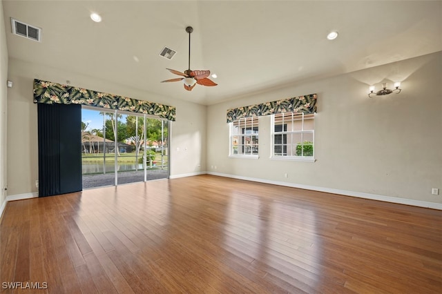 spare room with hardwood / wood-style flooring and ceiling fan