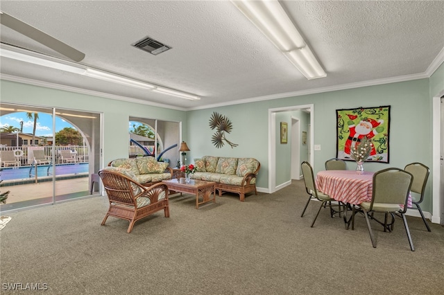 living room featuring a textured ceiling, carpet floors, and ornamental molding