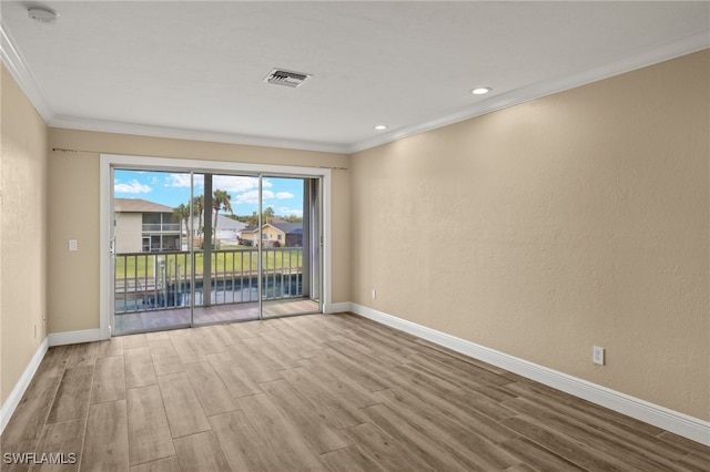 unfurnished room with light hardwood / wood-style floors and ornamental molding