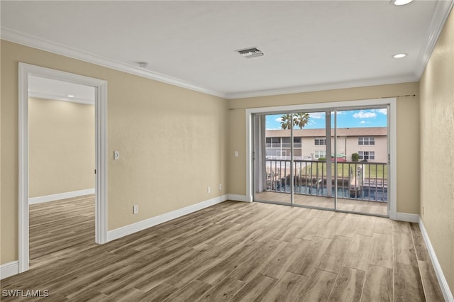 unfurnished room with wood-type flooring and ornamental molding