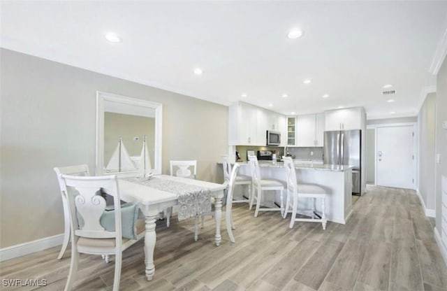 dining room with light hardwood / wood-style flooring