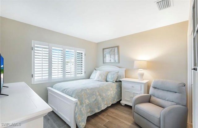 bedroom with dark hardwood / wood-style floors