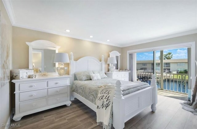 bedroom with dark hardwood / wood-style floors, access to exterior, crown molding, and a water view