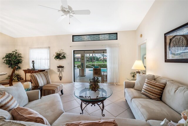 living room featuring a wealth of natural light, ceiling fan, and light tile patterned floors