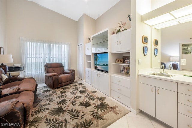 tiled living room featuring sink and high vaulted ceiling