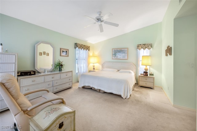 carpeted bedroom featuring vaulted ceiling and ceiling fan