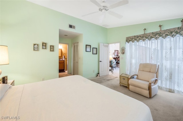 bedroom featuring lofted ceiling, light carpet, ceiling fan, and a closet