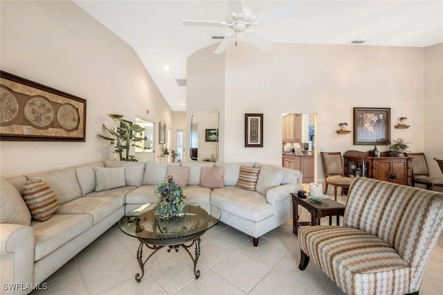 tiled living room featuring ceiling fan and high vaulted ceiling