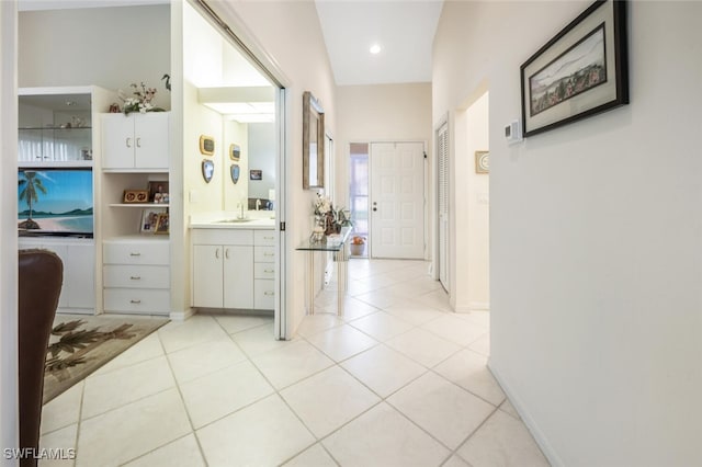 hallway with sink and light tile patterned floors