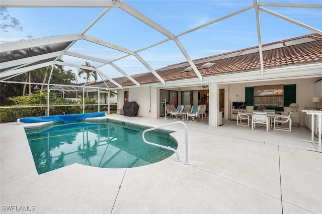 view of swimming pool featuring a patio, a lanai, and exterior bar