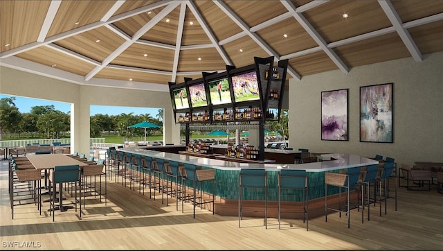 bar with a high ceiling, coffered ceiling, beam ceiling, and light hardwood / wood-style flooring