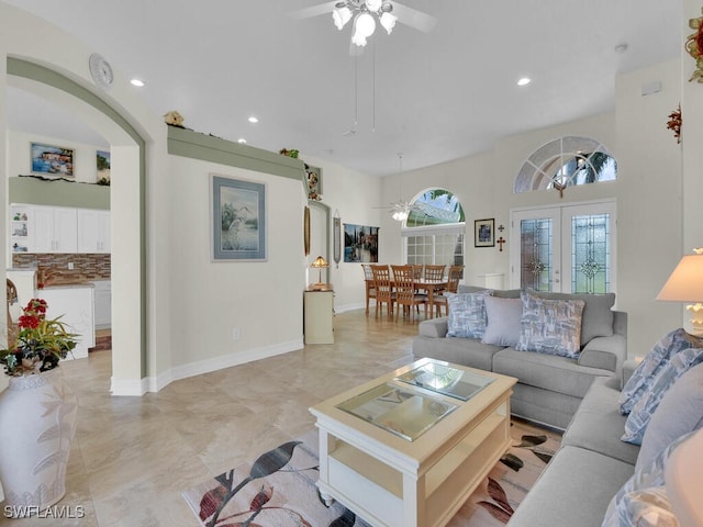 living room featuring ceiling fan and french doors