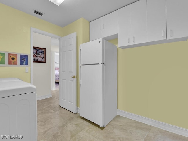 interior space featuring light tile patterned floors and washer / dryer