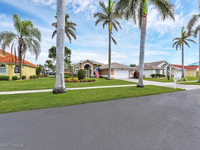 ranch-style home featuring a front lawn and a garage