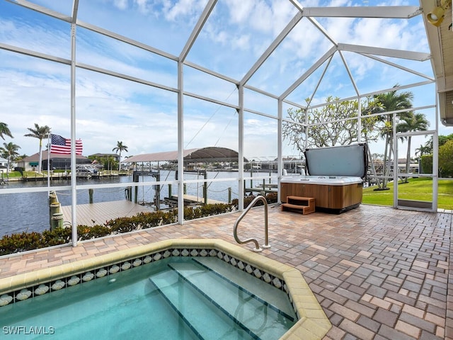 view of swimming pool featuring a patio, a water view, a hot tub, and glass enclosure