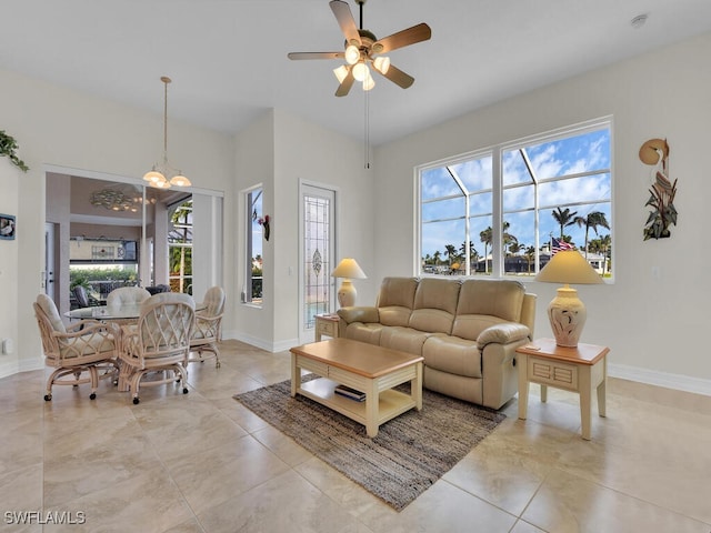 living room with a healthy amount of sunlight and ceiling fan with notable chandelier