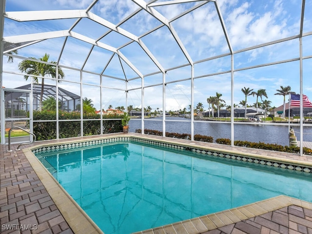 view of swimming pool featuring a lanai and a water view