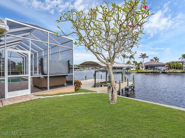 view of dock with a yard, a water view, a hot tub, and a lanai