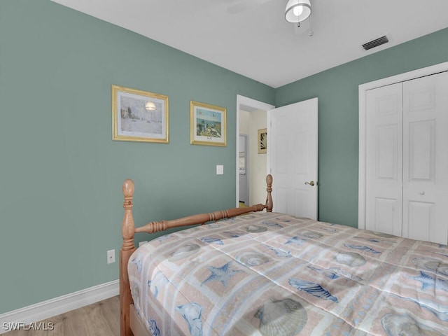 bedroom with ceiling fan, a closet, and light hardwood / wood-style floors