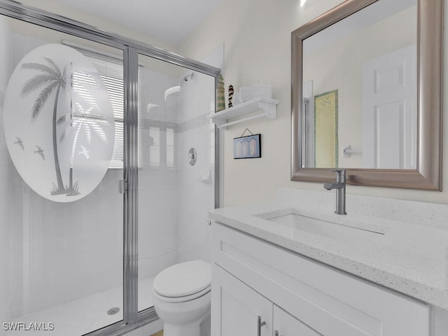 bathroom featuring vanity, toilet, and walk in shower