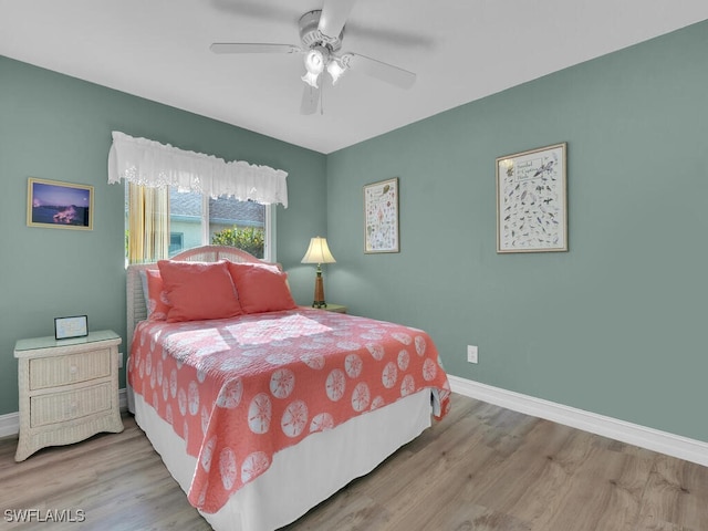 bedroom with ceiling fan and light hardwood / wood-style flooring