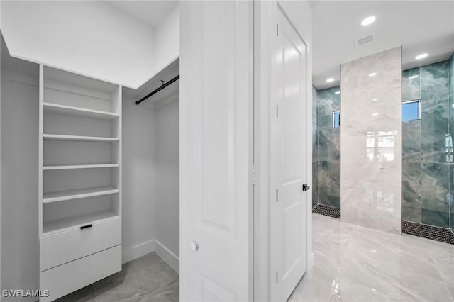 spacious closet featuring a barn door